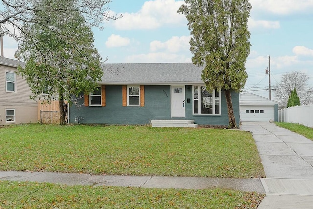 ranch-style home with a front lawn, an outdoor structure, and a garage