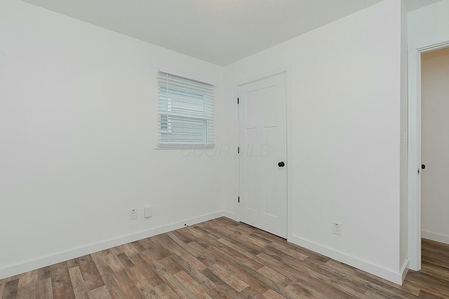 empty room with hardwood / wood-style floors