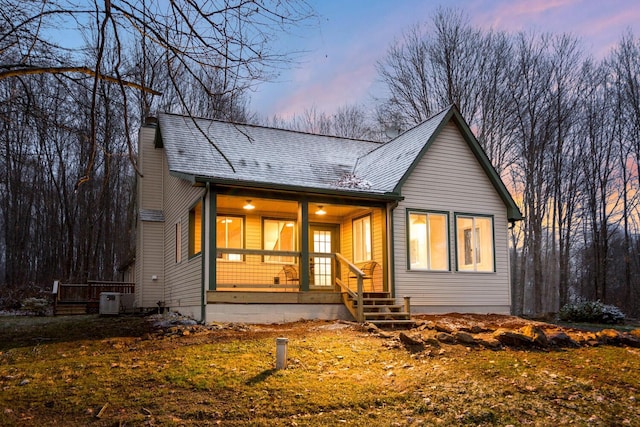 view of front of property with covered porch and central air condition unit