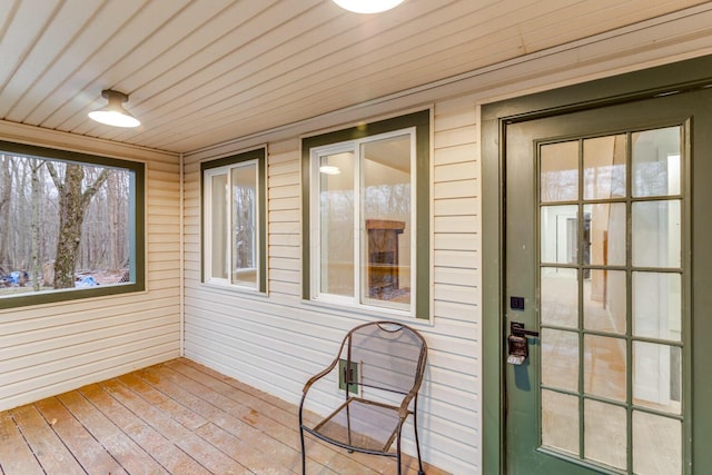 unfurnished sunroom with wooden ceiling