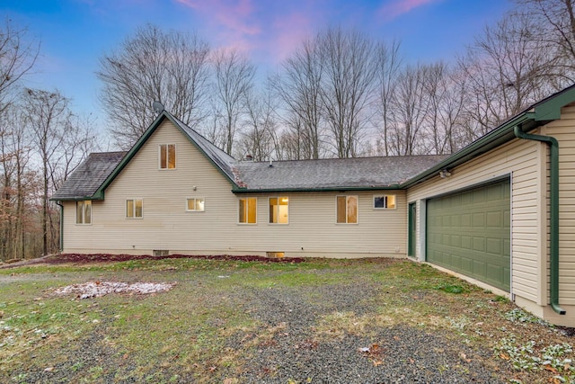 property exterior at dusk featuring a garage