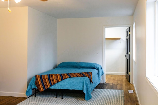 bedroom with dark wood-type flooring