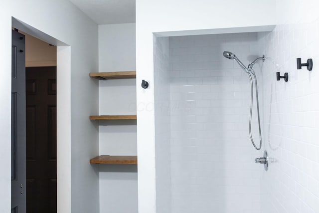 bathroom with tiled shower