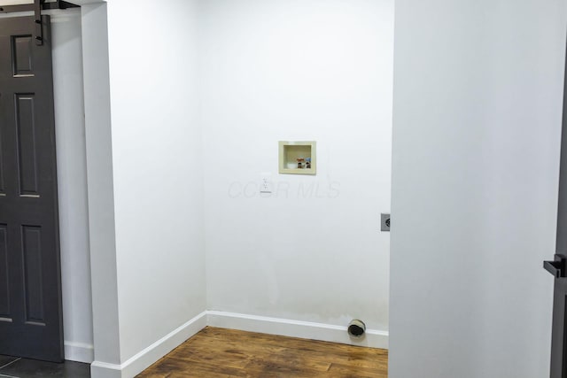 laundry area with washer hookup, a barn door, dark hardwood / wood-style floors, and electric dryer hookup