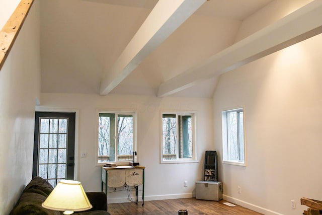 living area featuring wood-type flooring and lofted ceiling with beams