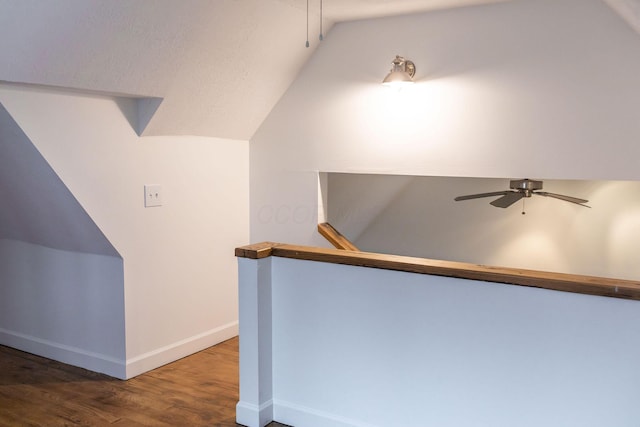 interior space featuring dark wood-type flooring and lofted ceiling