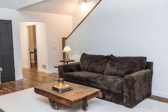 living room featuring hardwood / wood-style flooring and vaulted ceiling