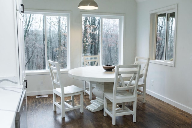 dining area with dark wood-type flooring