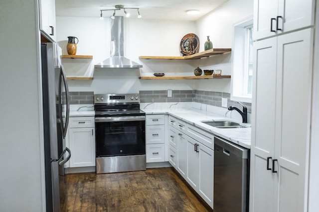 kitchen featuring white cabinetry, sink, stainless steel appliances, and wall chimney range hood