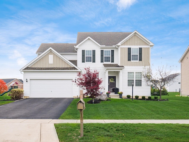 view of front of home with a front yard and a garage