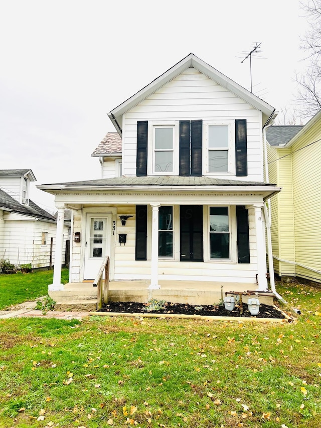 view of front of house featuring a front lawn and covered porch