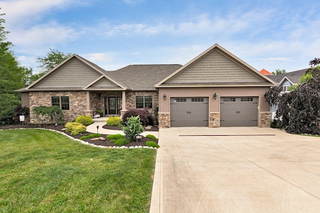 craftsman house featuring a garage and a front lawn