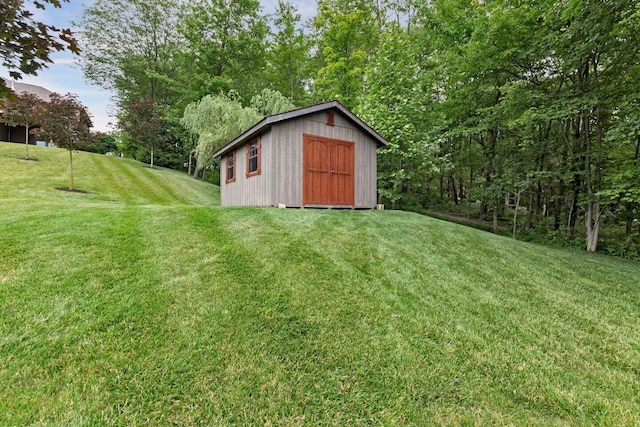 view of outbuilding with a yard