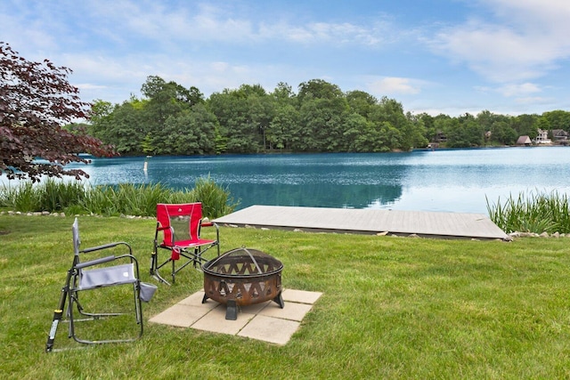 view of yard featuring a fire pit and a water view