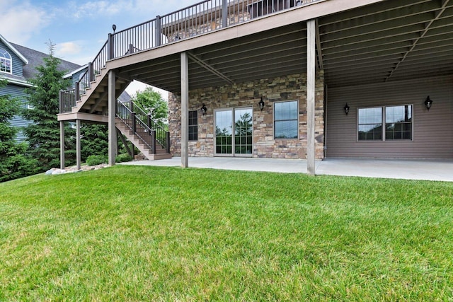 rear view of property with a patio area, a yard, and a deck