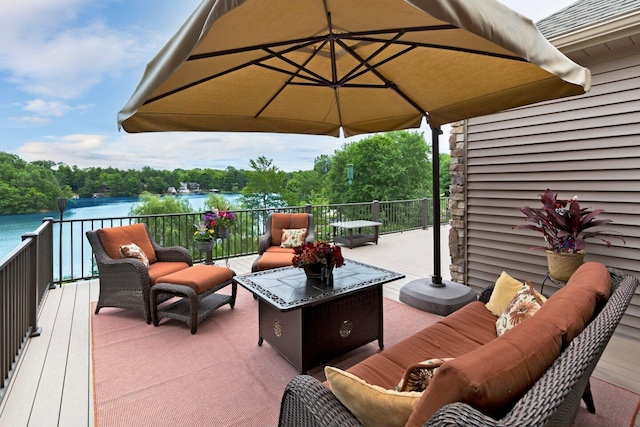 wooden terrace featuring an outdoor hangout area and a water view