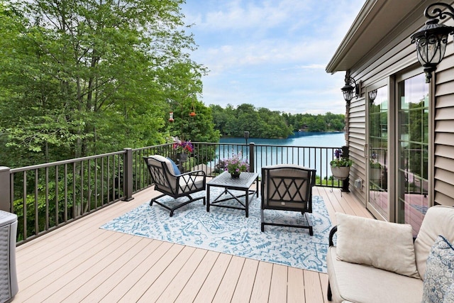 wooden terrace with outdoor lounge area and a water view