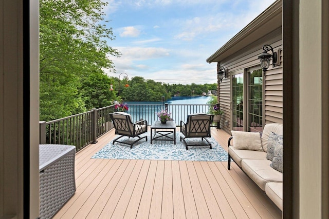 wooden terrace featuring an outdoor living space and a water view