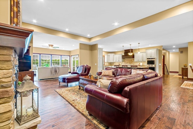 living room with hardwood / wood-style floors and ceiling fan