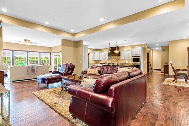 living room featuring dark hardwood / wood-style floors and ceiling fan