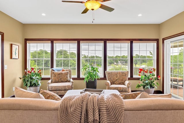 sunroom featuring ceiling fan