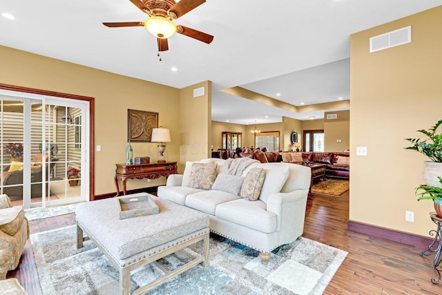 living room featuring hardwood / wood-style floors and ceiling fan