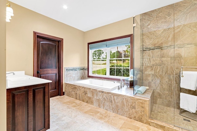 bathroom featuring plus walk in shower and vanity