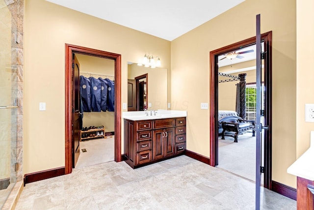 bathroom featuring vanity, walk in shower, and ceiling fan