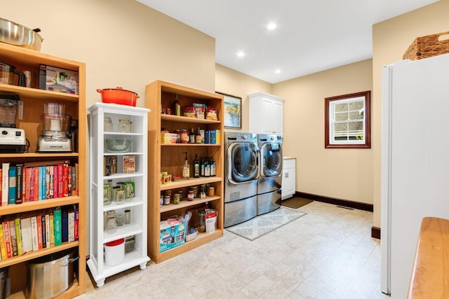 laundry area featuring cabinets and washing machine and dryer