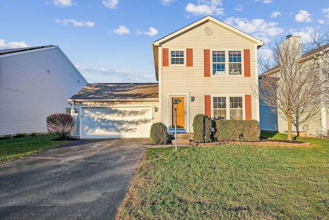 view of property featuring a front yard and a garage