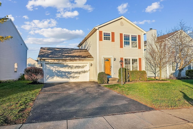 front facade featuring a front yard and a garage