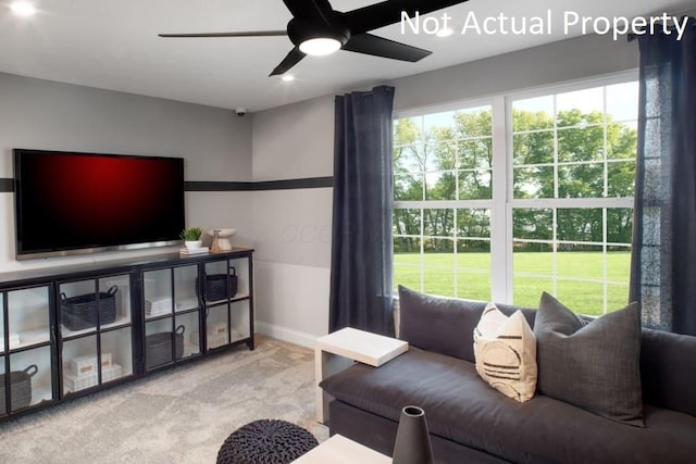 carpeted living room featuring ceiling fan