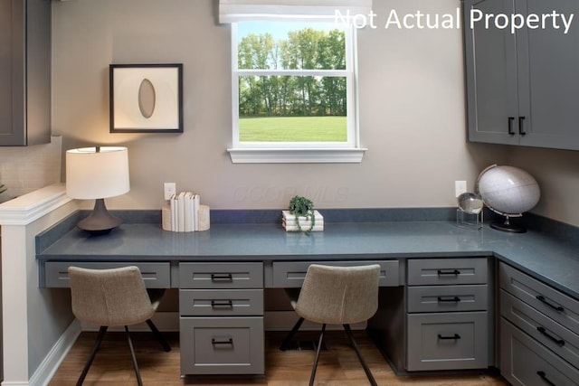 home office featuring a wealth of natural light and hardwood / wood-style flooring