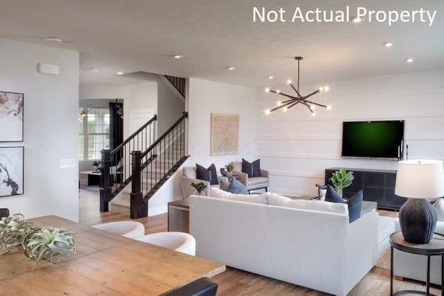 living room with light hardwood / wood-style flooring and a chandelier