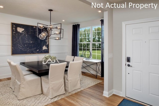 dining space featuring hardwood / wood-style floors and a notable chandelier