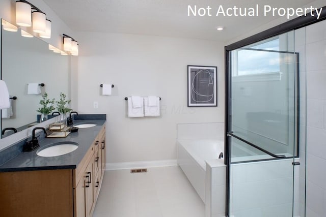 bathroom featuring plus walk in shower and vanity