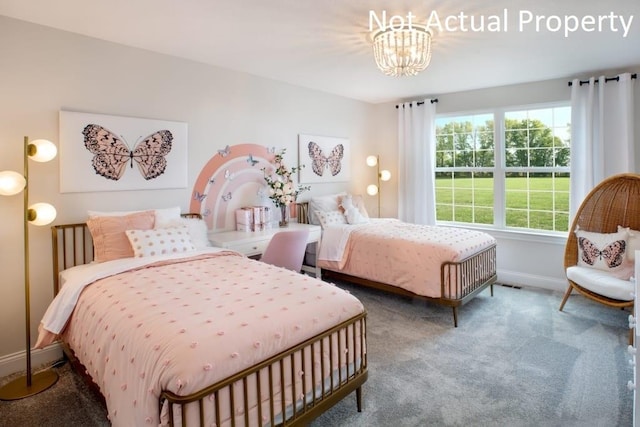 bedroom featuring carpet floors and a chandelier