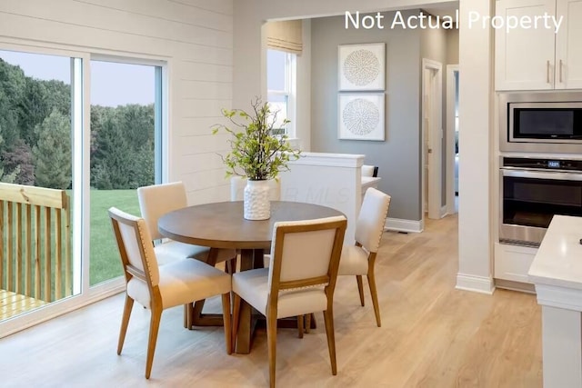 dining space with light wood-type flooring