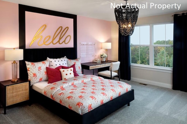 bedroom featuring carpet flooring and an inviting chandelier