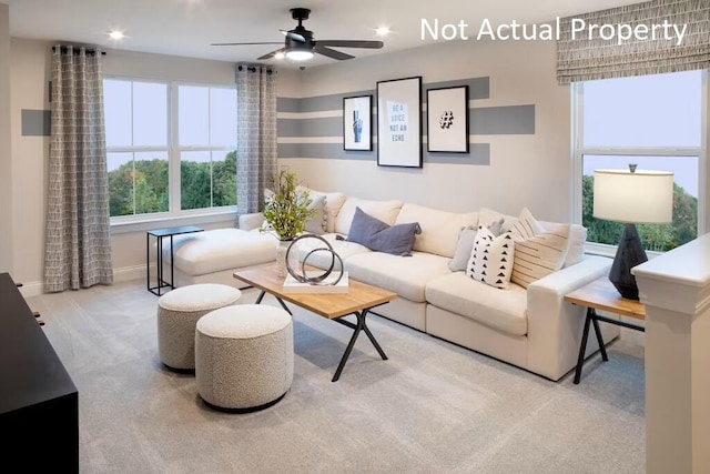 carpeted living room featuring ceiling fan