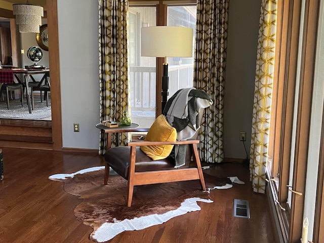 sitting room with wood-type flooring