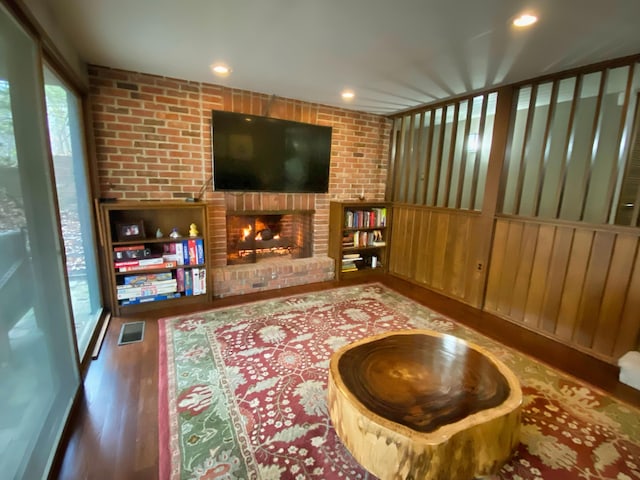 living room with a fireplace and dark hardwood / wood-style floors