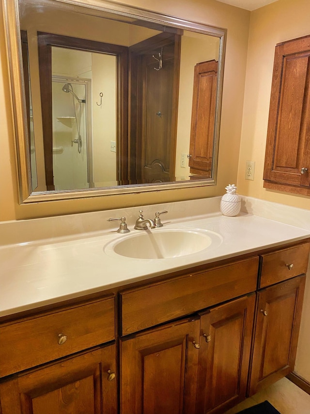 bathroom featuring vanity and a shower with door