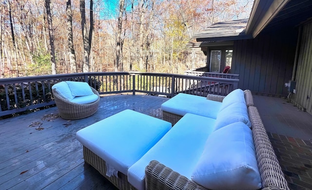 wooden terrace featuring outdoor lounge area