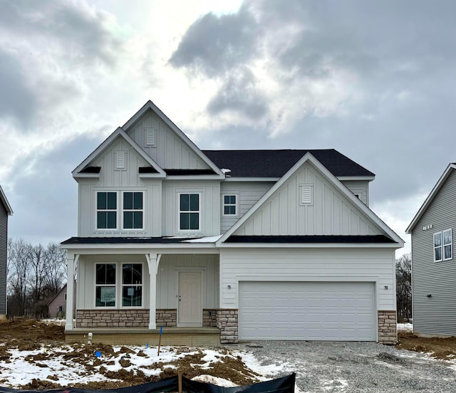 craftsman inspired home featuring covered porch and a garage