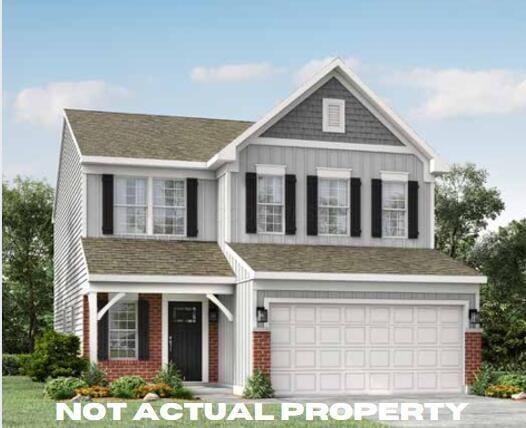 craftsman-style house with brick siding, board and batten siding, and an attached garage