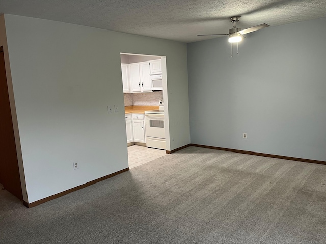 unfurnished living room with light carpet, a textured ceiling, and ceiling fan