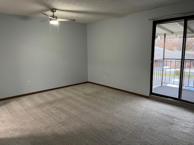 unfurnished room with carpet flooring, ceiling fan, and a textured ceiling