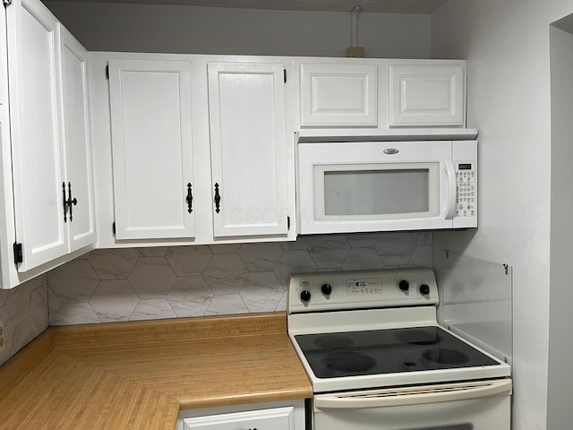 kitchen featuring decorative backsplash, white cabinetry, and white appliances