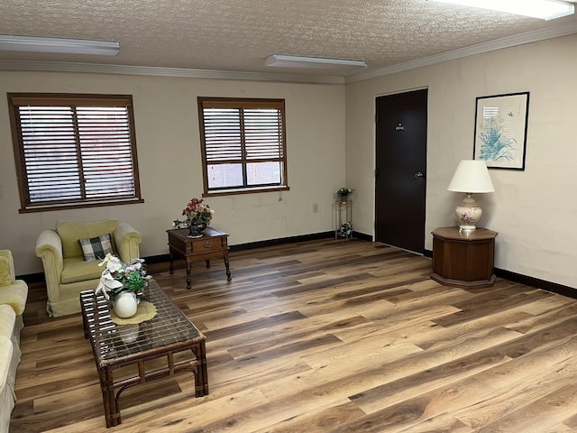 interior space featuring a textured ceiling, hardwood / wood-style flooring, and ornamental molding